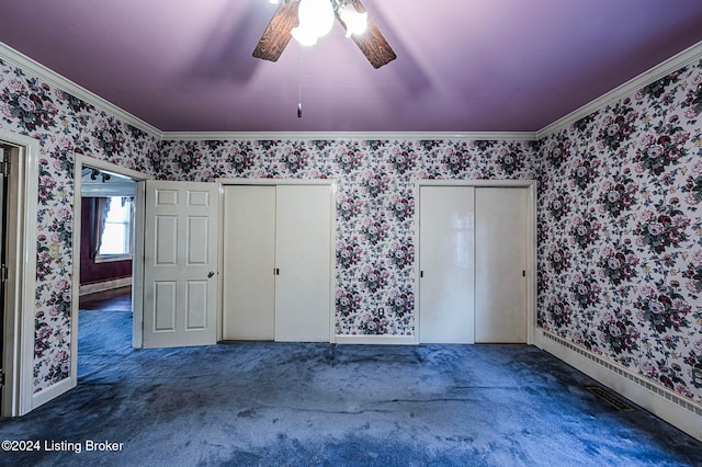 unfurnished bedroom with multiple closets, dark colored carpet, and ceiling fan