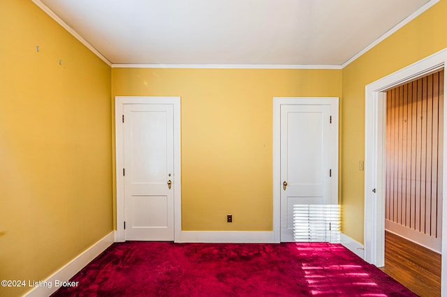 unfurnished bedroom with crown molding and carpet floors