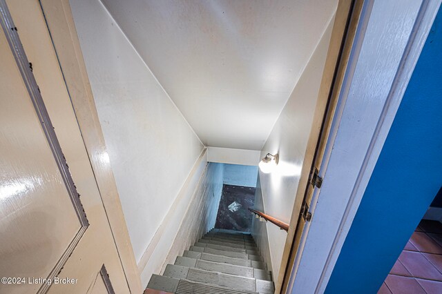 staircase featuring tile patterned floors