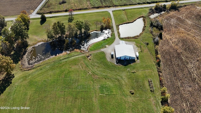 birds eye view of property with a water view and a rural view