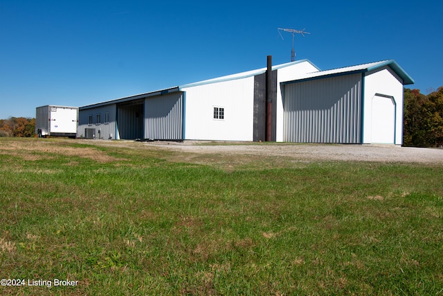 garage featuring central air condition unit and a lawn