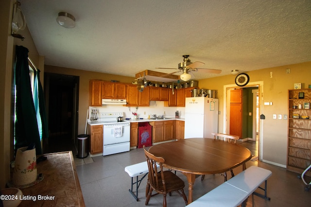 kitchen with a textured ceiling, ceiling fan, sink, and white appliances