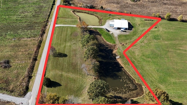 birds eye view of property featuring a water view and a rural view