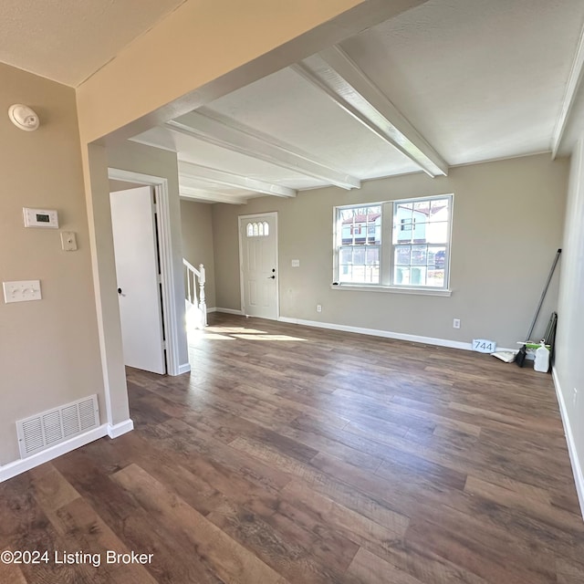 interior space featuring dark hardwood / wood-style flooring and beamed ceiling