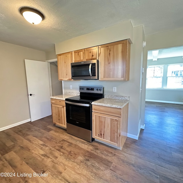 744 Brian Ct, Radcliff, KY 40160 - kitchen with stainless steel appliances, dark wood finished floors, light brown cabinetry, a textured ceiling, and baseboards
