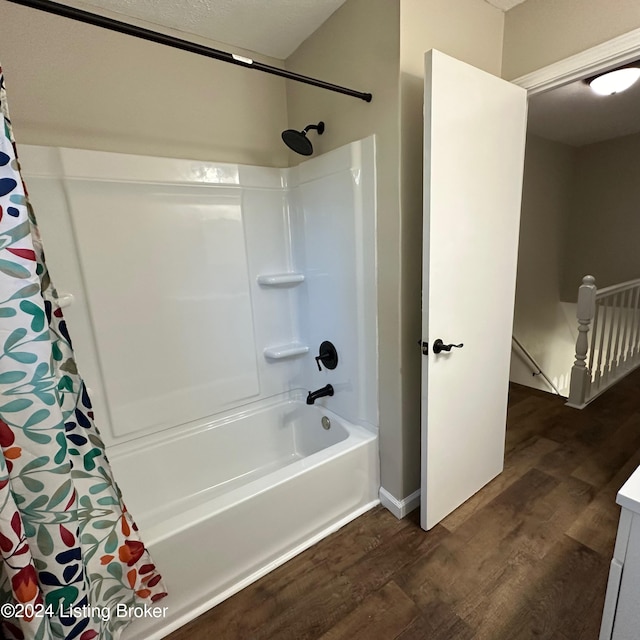 bathroom featuring hardwood / wood-style flooring, vanity, and shower / bath combo