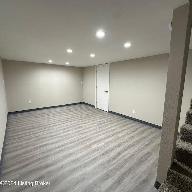 basement with light hardwood / wood-style flooring