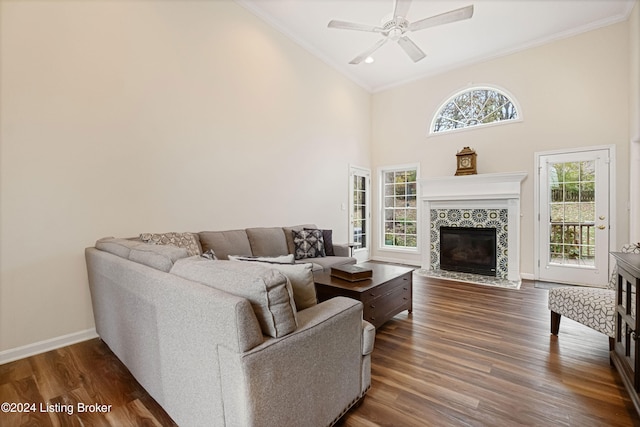 living room featuring dark hardwood / wood-style floors, ceiling fan, and a healthy amount of sunlight