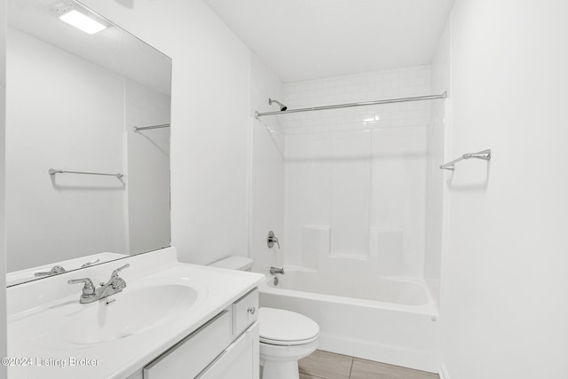 full bathroom featuring tiled shower / bath, vanity, and toilet