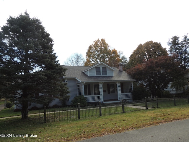 view of front of house with covered porch and a front lawn