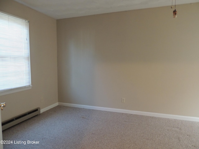 carpeted empty room with plenty of natural light and a baseboard radiator