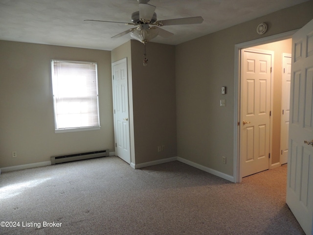 carpeted empty room with baseboard heating and ceiling fan