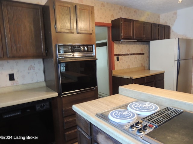 kitchen featuring black appliances and dark brown cabinets