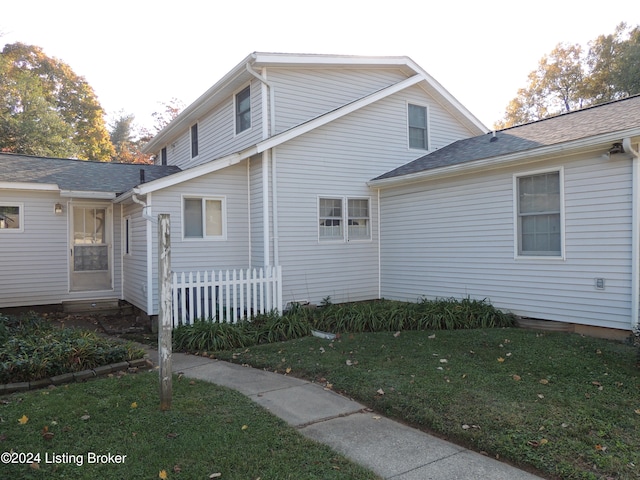 view of side of property with a yard