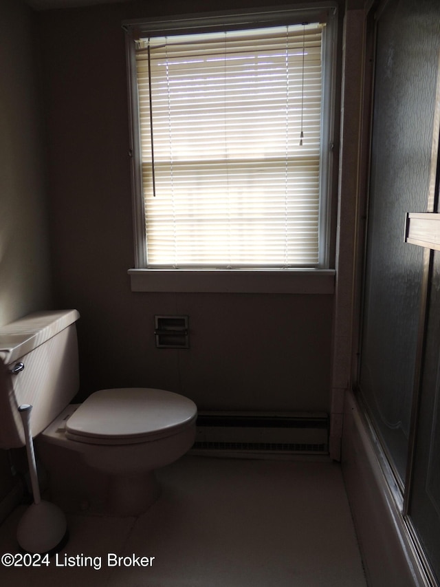 bathroom featuring toilet, enclosed tub / shower combo, and a baseboard radiator