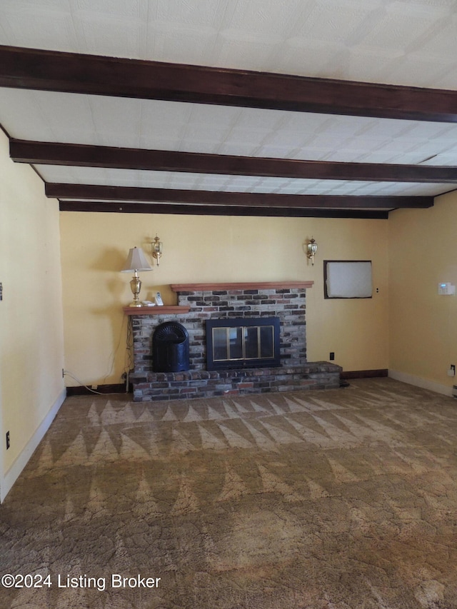 unfurnished living room with carpet flooring, beam ceiling, and a brick fireplace