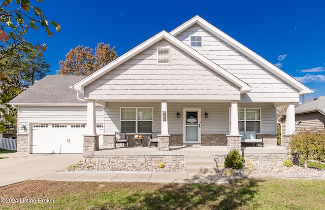 craftsman inspired home with covered porch and a garage