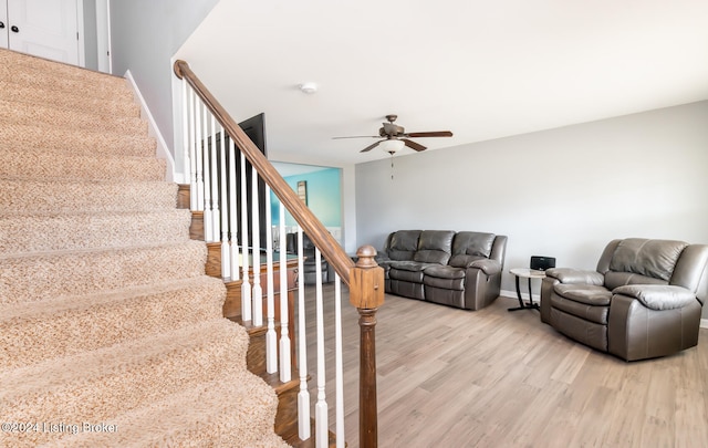 living room featuring light hardwood / wood-style floors and ceiling fan