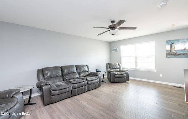 living room with light hardwood / wood-style flooring and ceiling fan