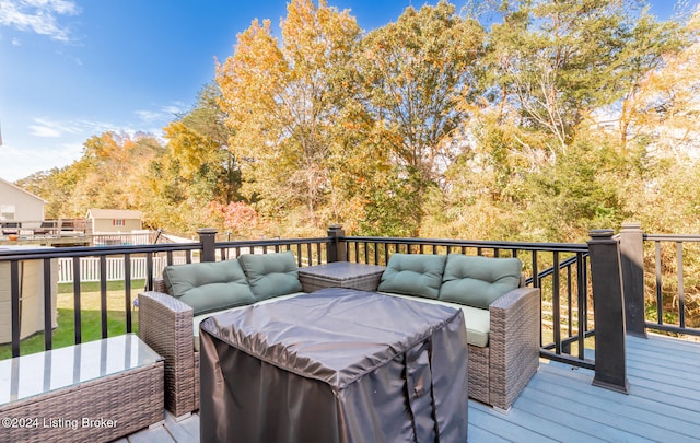 wooden deck with an outdoor living space