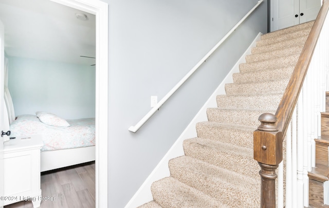 stairway with hardwood / wood-style flooring