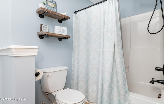 bathroom with shower / bath combo with shower curtain and toilet