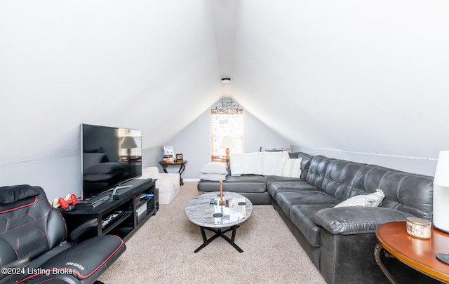 carpeted living room featuring vaulted ceiling