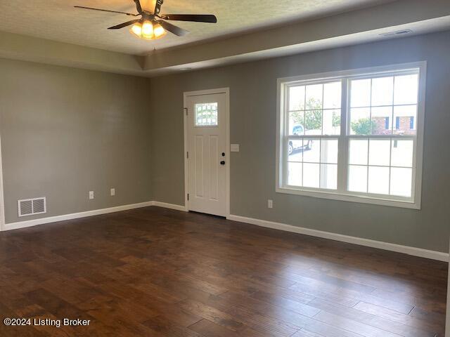 foyer entrance featuring dark wood-type flooring and ceiling fan