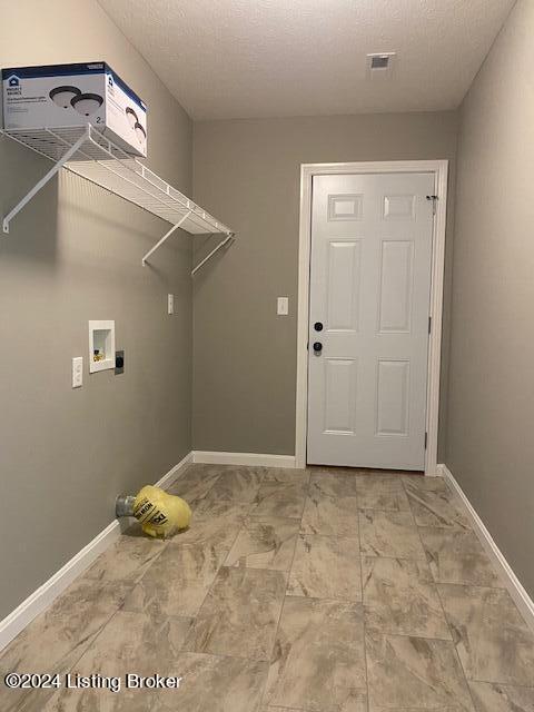 laundry area featuring a textured ceiling, washer hookup, and electric dryer hookup