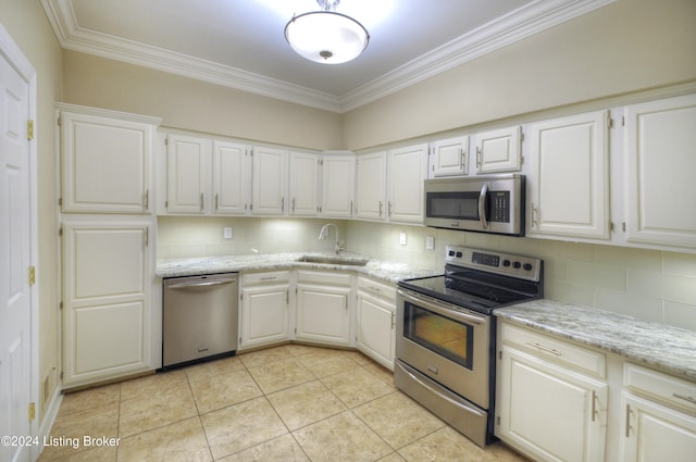 kitchen with white cabinets, sink, appliances with stainless steel finishes, and tasteful backsplash