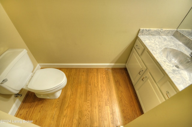 bathroom featuring hardwood / wood-style floors, vanity, and toilet