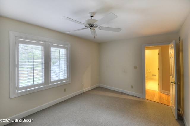 unfurnished room featuring ceiling fan and carpet floors