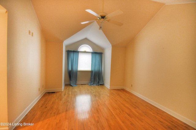 spare room with ceiling fan, light hardwood / wood-style flooring, and lofted ceiling