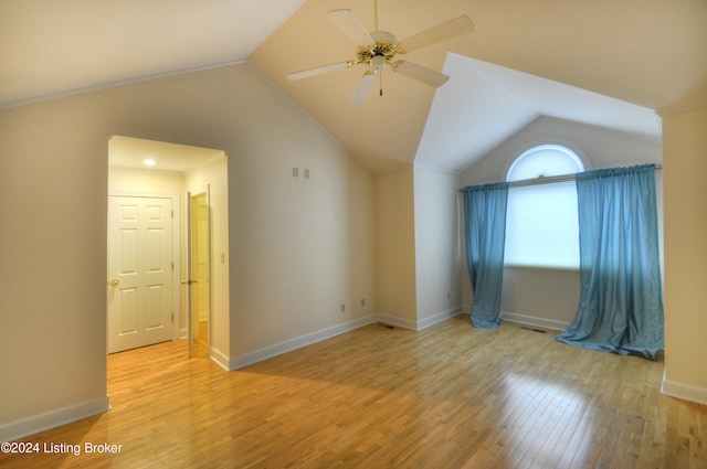 empty room featuring ceiling fan, light hardwood / wood-style floors, lofted ceiling, and ornamental molding