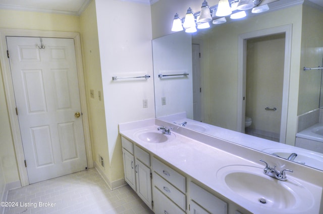 bathroom featuring vanity, a bath, tile patterned floors, crown molding, and toilet