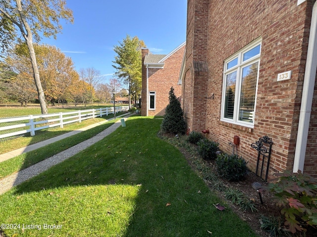 view of side of home featuring a yard