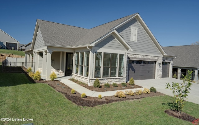 view of front of house featuring a garage and a front lawn