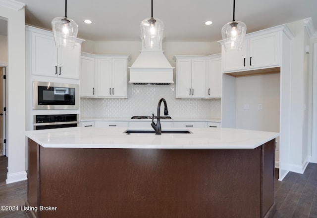 kitchen with dark hardwood / wood-style floors, stainless steel appliances, and hanging light fixtures