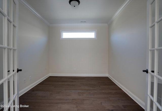 empty room featuring french doors, crown molding, and dark hardwood / wood-style flooring