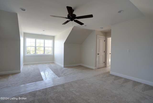 bonus room featuring light colored carpet and ceiling fan