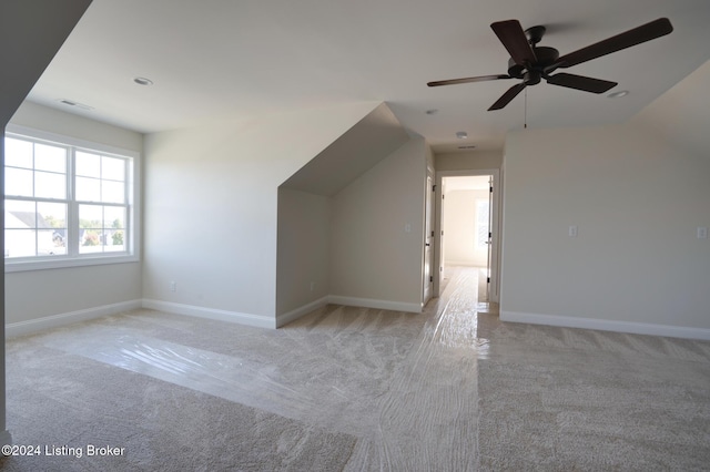 bonus room with ceiling fan, lofted ceiling, and light colored carpet