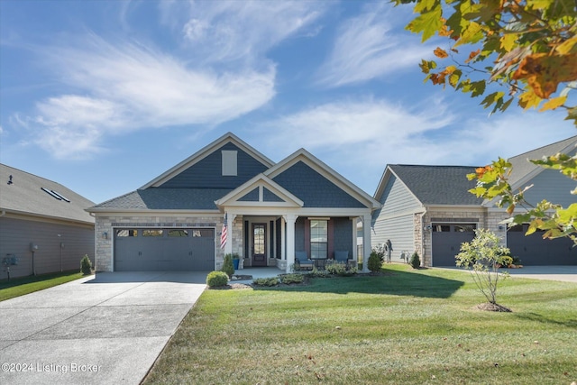 view of front of home with a front yard and a garage