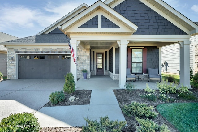 view of front of home featuring a porch and a garage