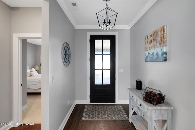 foyer entrance featuring crown molding, a notable chandelier, and dark hardwood / wood-style flooring