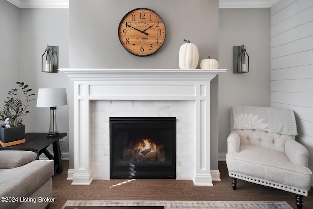 living room featuring ornamental molding and dark hardwood / wood-style flooring