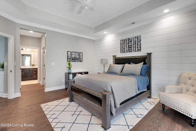 bedroom featuring light hardwood / wood-style flooring, ornamental molding, ensuite bathroom, and ceiling fan