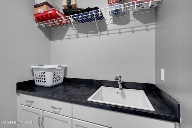 kitchen with white cabinetry and sink