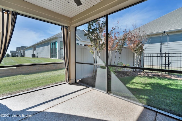 unfurnished sunroom featuring wood ceiling and ceiling fan