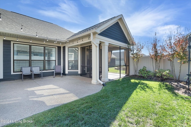 rear view of property with a patio and a yard