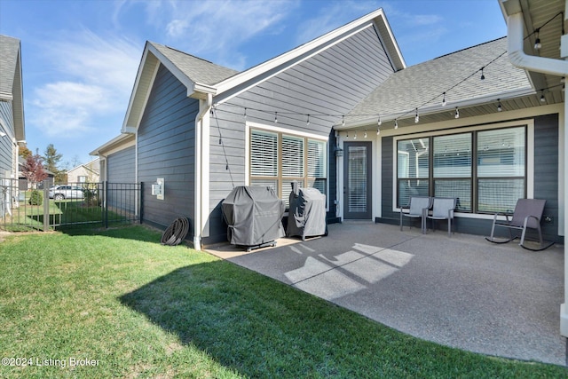 rear view of house featuring a patio and a lawn